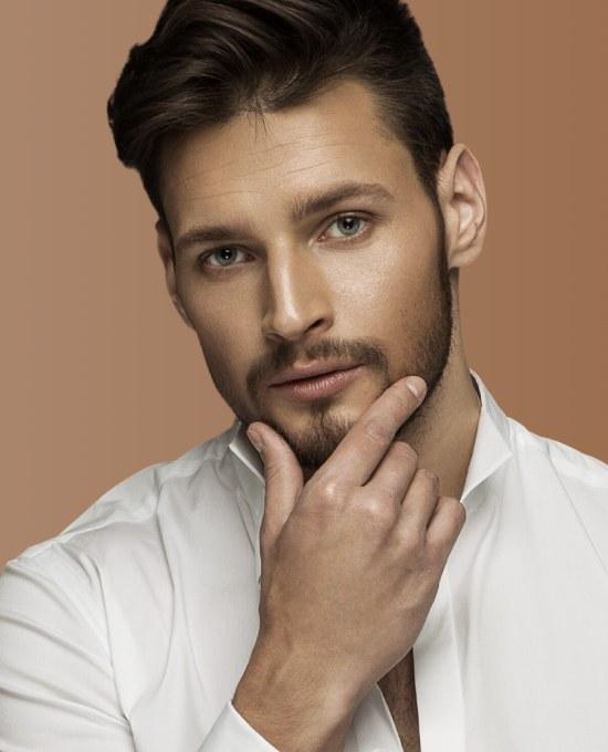 Portrait of handsome man with blue eyes and beard, looking sexy, wearing white shirt